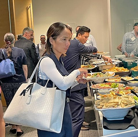 Attendees enjoy a sampling of delicious appetizers and beverages in Morgan Lewis’ reception area.